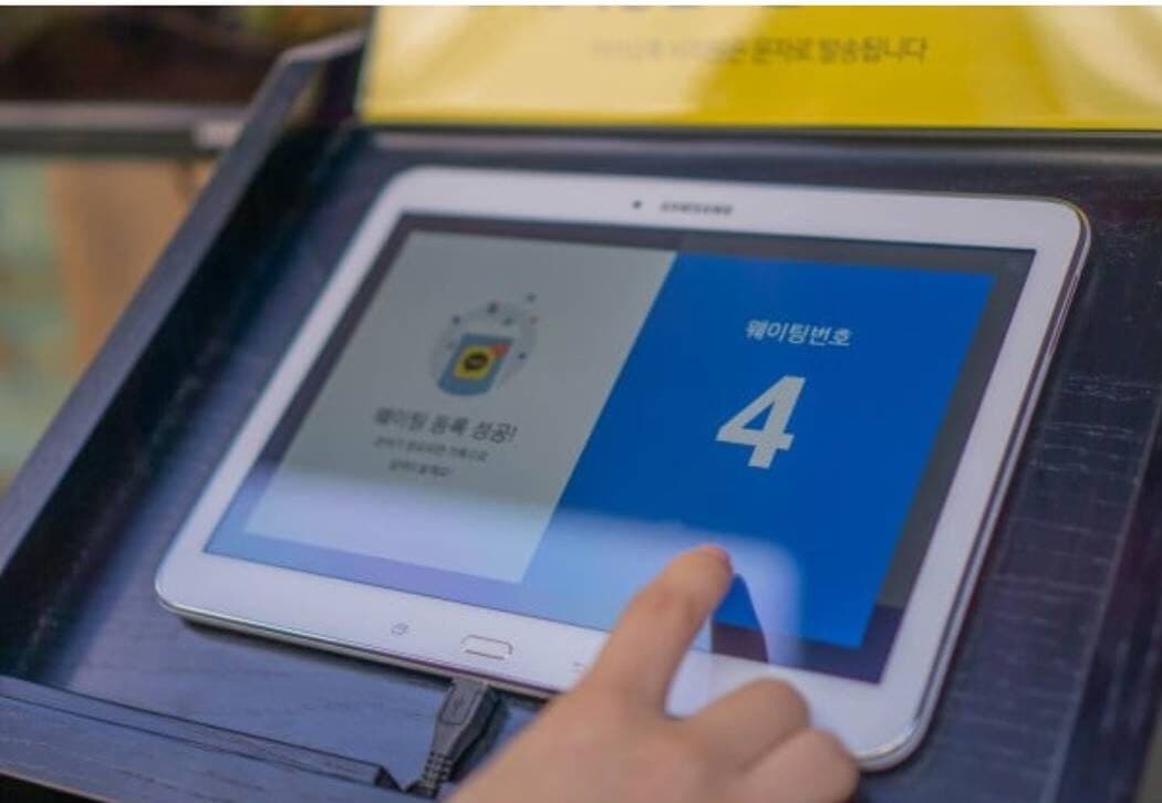 Someone is entering information into the waiting system.