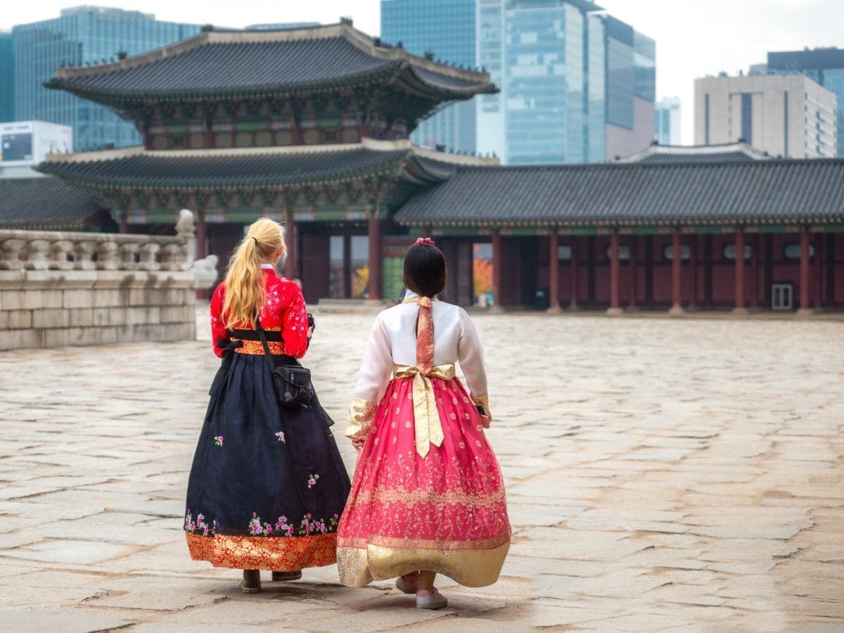 Tourists in hanbok walking through the palace