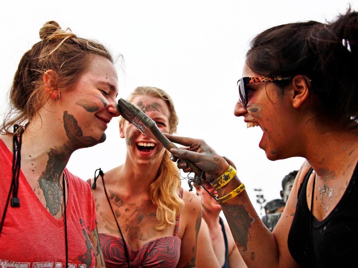 Women applying mud to their faces at the Boryeong Mud Festival