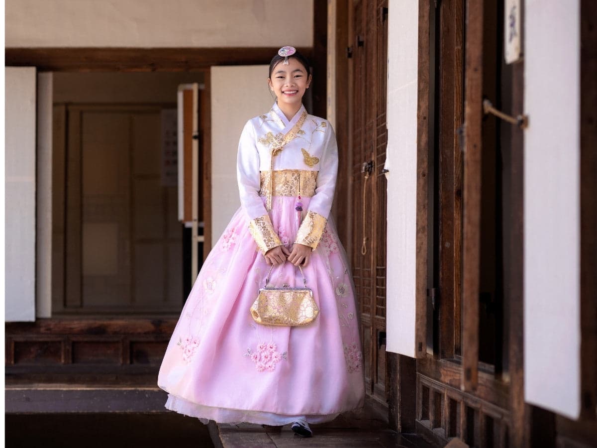a girl in hanbok of white and pink