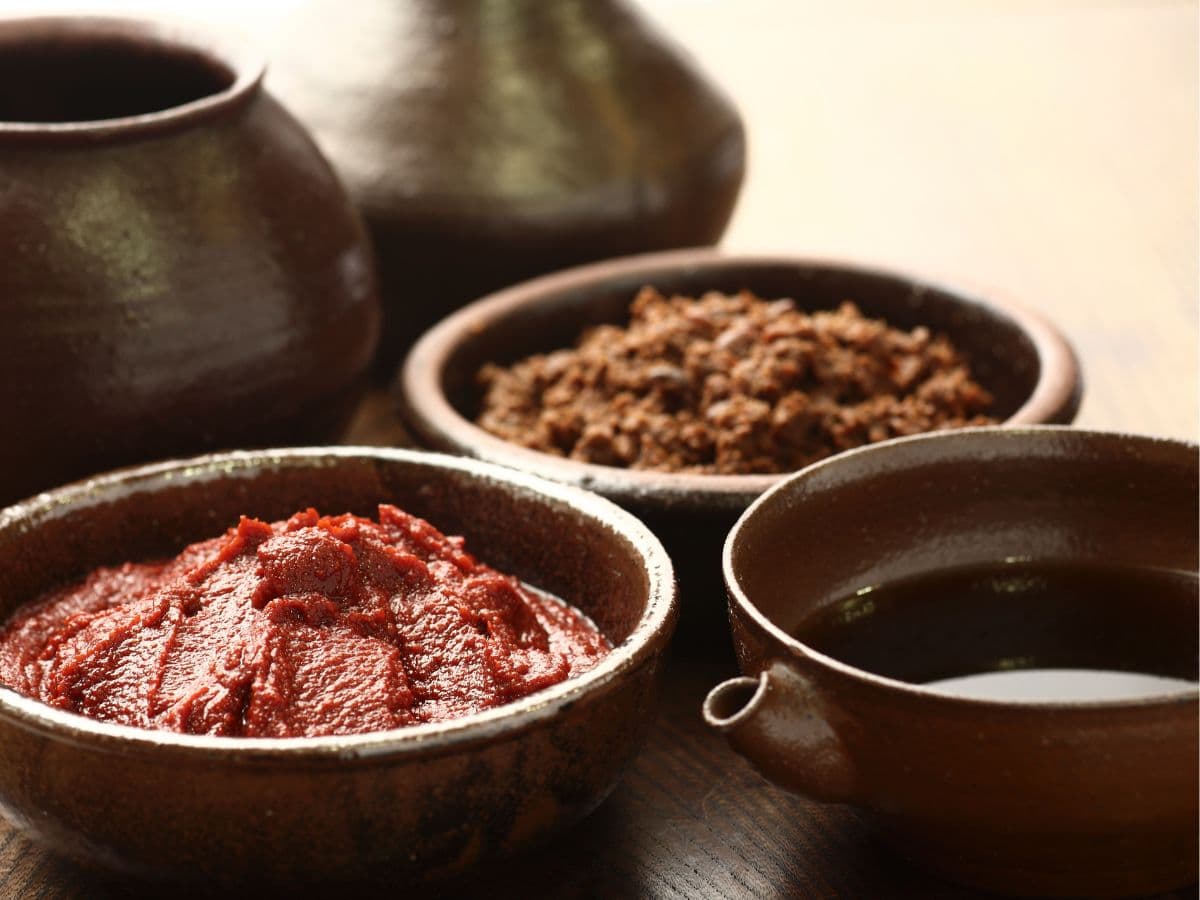 3 plates filled with Korea's mother sauces: gochujang, doenjang, ganjang